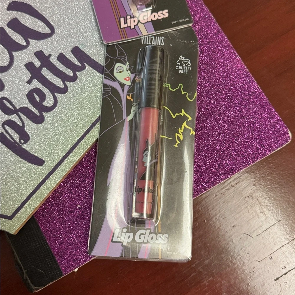 NWT 2 color DISNEY Female VILLAINS cruelty free lip gloss. Yes I see the irony.